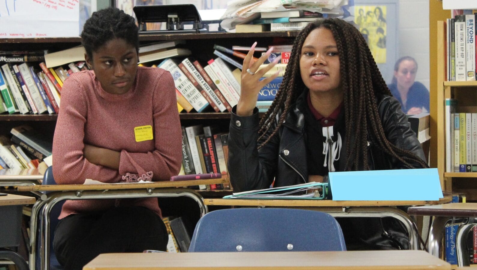 Two students having respectful discourse while seated at desks during a Speak Truth event
