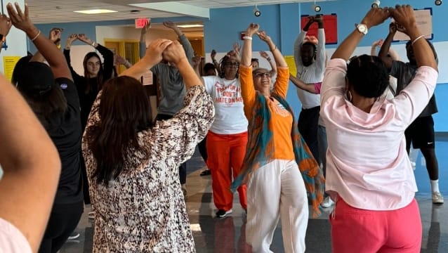 ProfessionalDevelopment A group of teachers sitting casually in a circle on the ground, having a conversation during an Inspired Teaching Institute