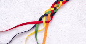 a rope with all the colors of the rainbow is braided together, with the ends left undone, symbolizing integrity