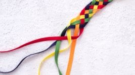 a rope with all the colors of the rainbow is braided together, with the ends left undone, symbolizing integrity