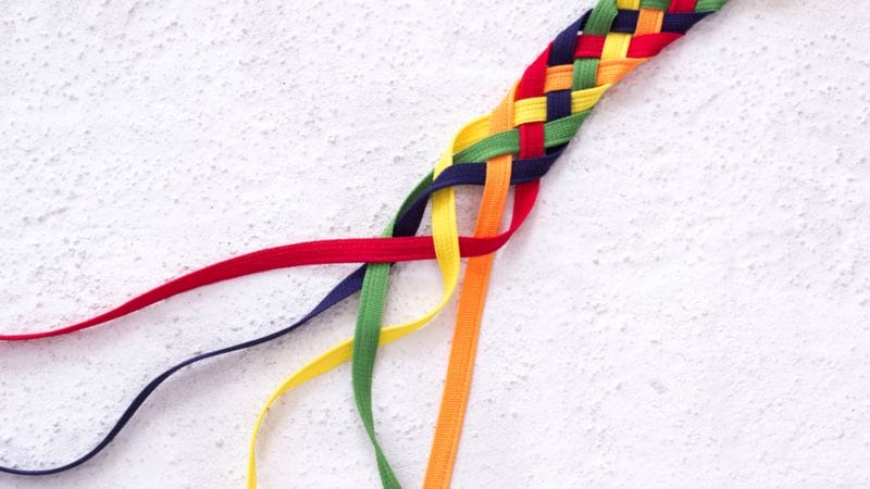 integritytw a rope with all the colors of the rainbow is braided together, with the ends left undone, symbolizing integrity